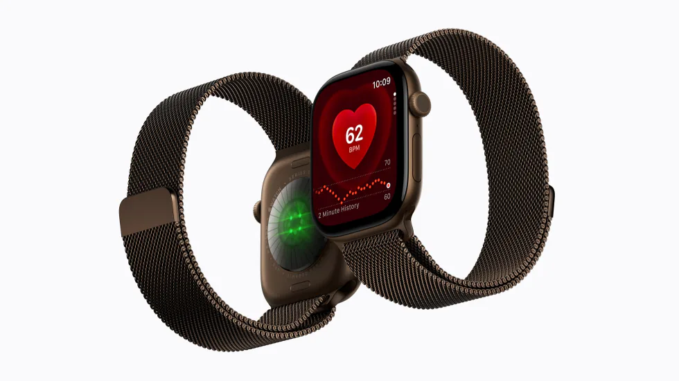 Apple Watch Series 12 with a bronze Milanese Loop, from the front showing the Heart Rate app and from the back showing its health sensors